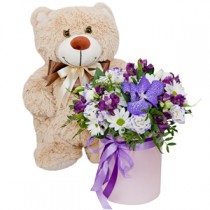 Airy flower arrangement with a teddy bear